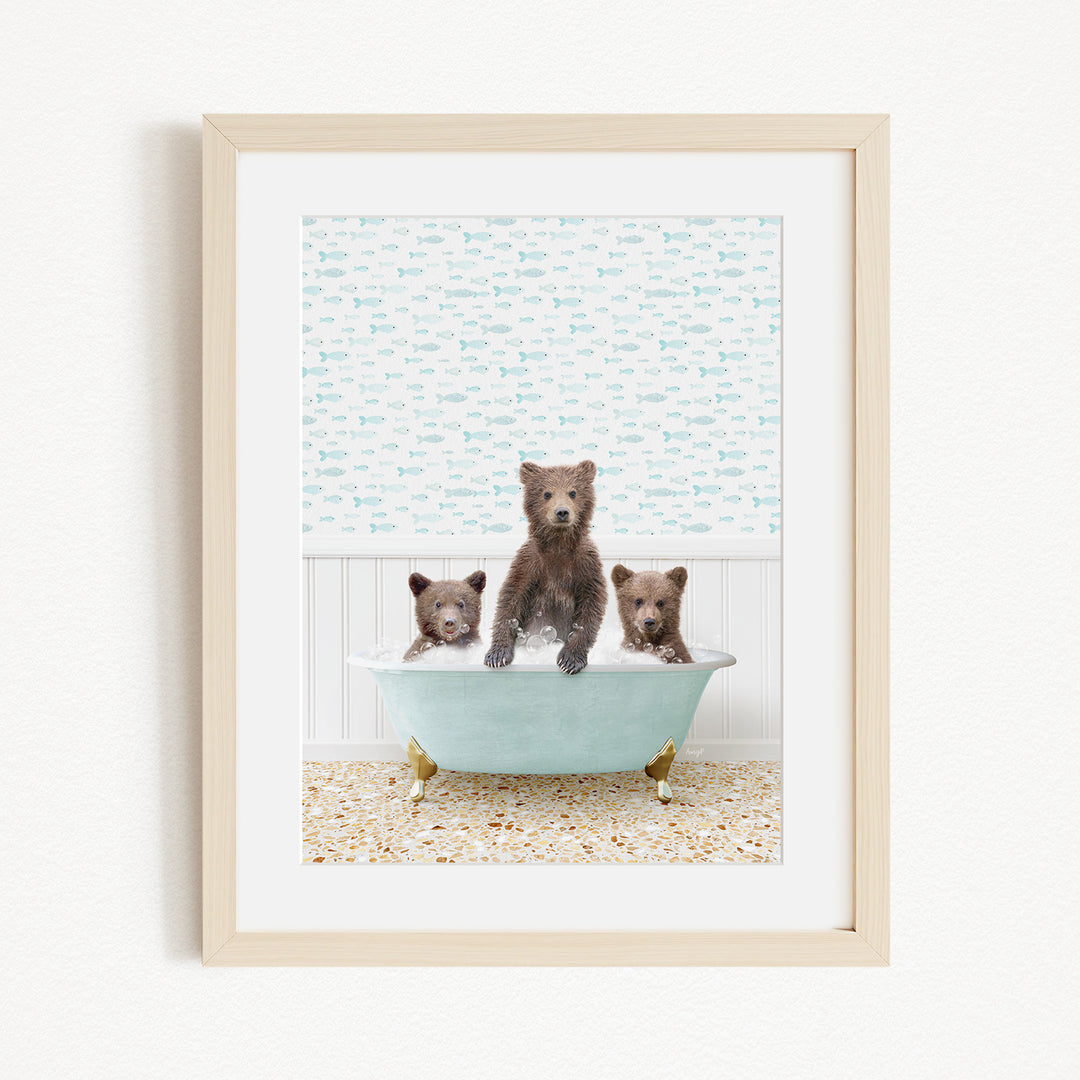 A framed image depicting three bears sitting in a bathtub filled with bubbles.