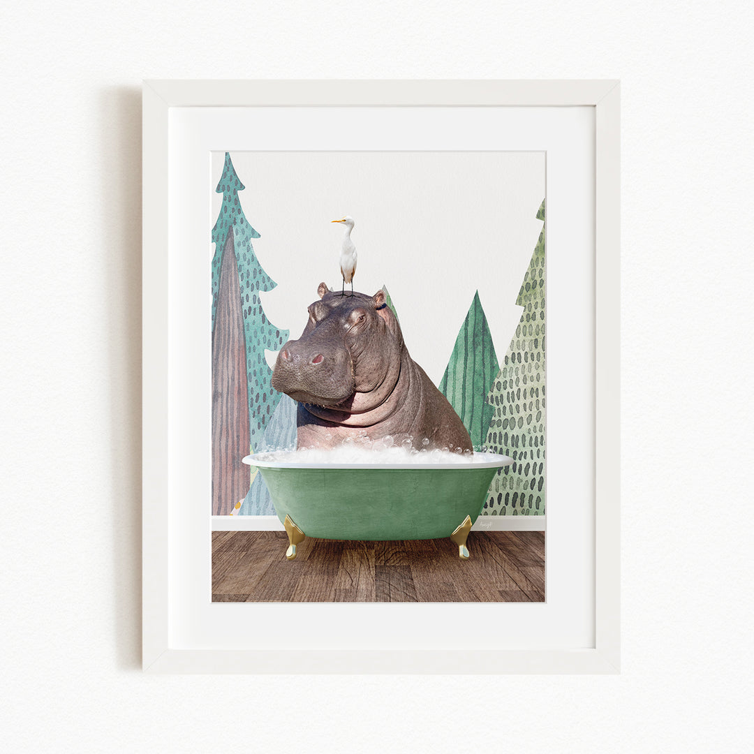 A framed image depicting a hippopotamus sitting in a green bathtub, with a bird perched on its head.