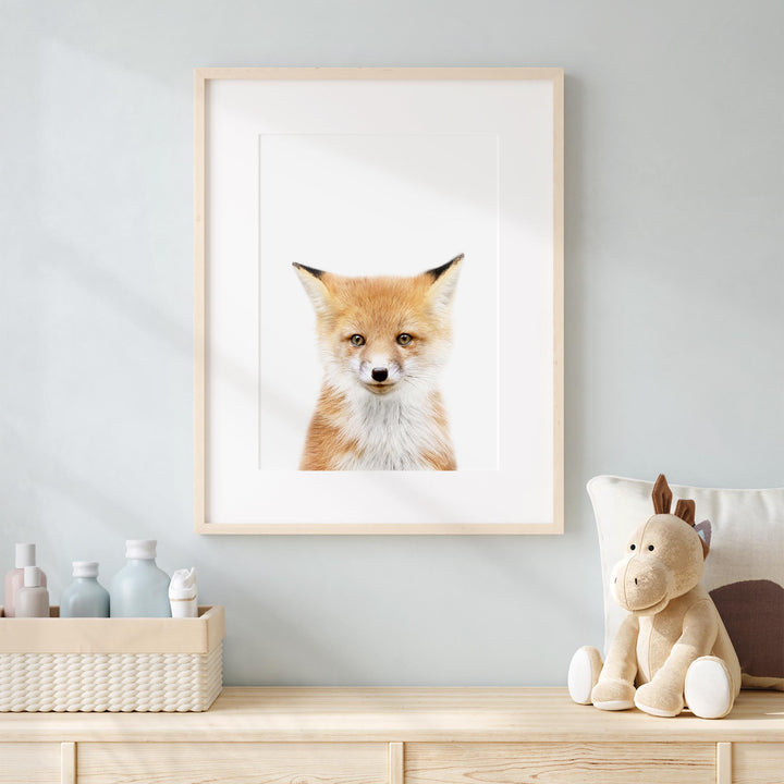 a picture of a fox is hanging on a wall