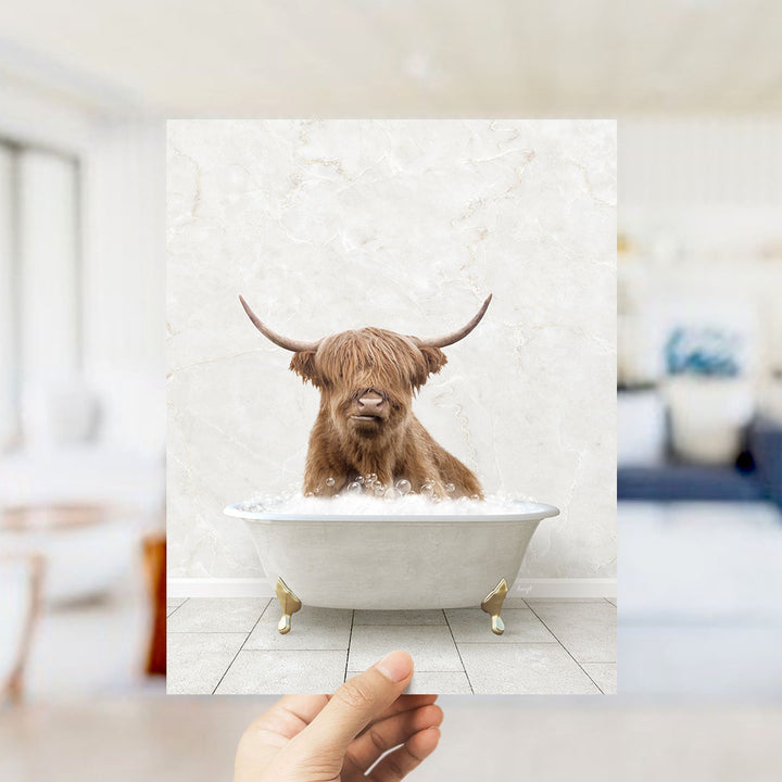 A brown cow with long horns is sitting in a white bathtub filled with water, appearing to enjoy the bath.