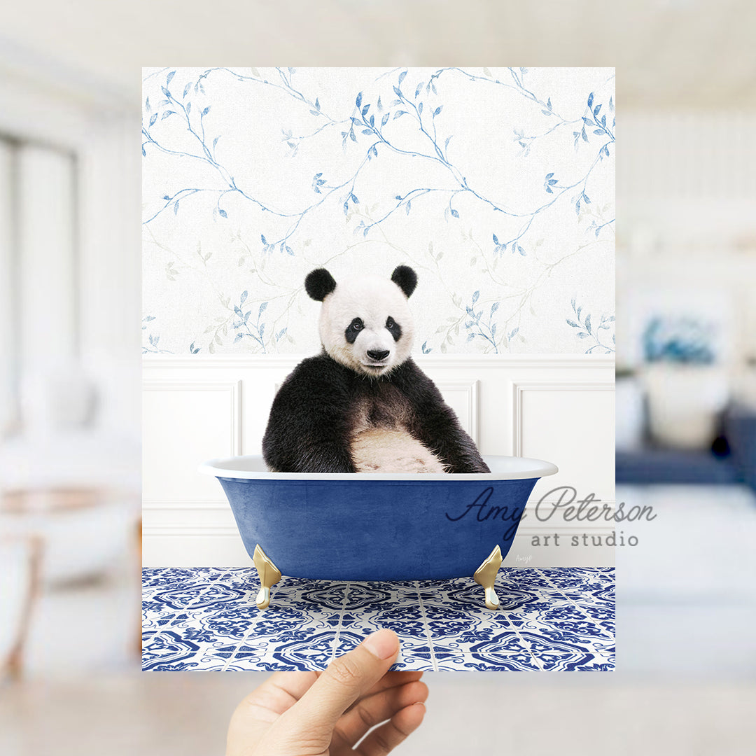 a panda bear sitting in a blue bath tub