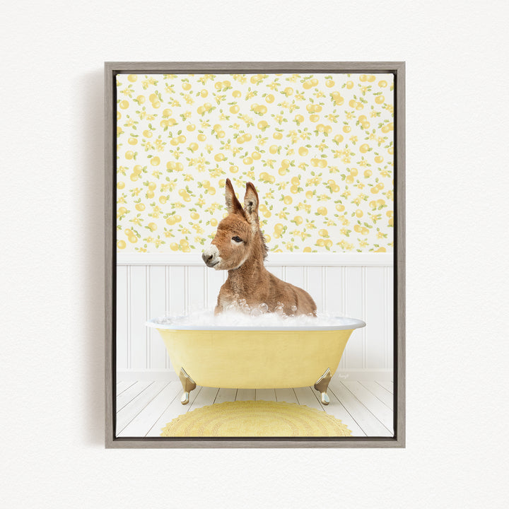 A donkey is sitting in a yellow bathtub filled with bubbles, surrounded by a yellow and white floral patterned wall.