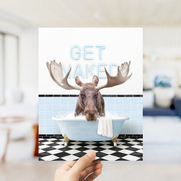 A moose with large antlers is sitting in a bathtub, with the words "GET NAKED" written above it.