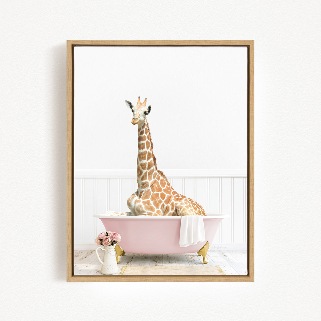 A giraffe sitting in a pink bathtub, surrounded by flowers and a white vase.