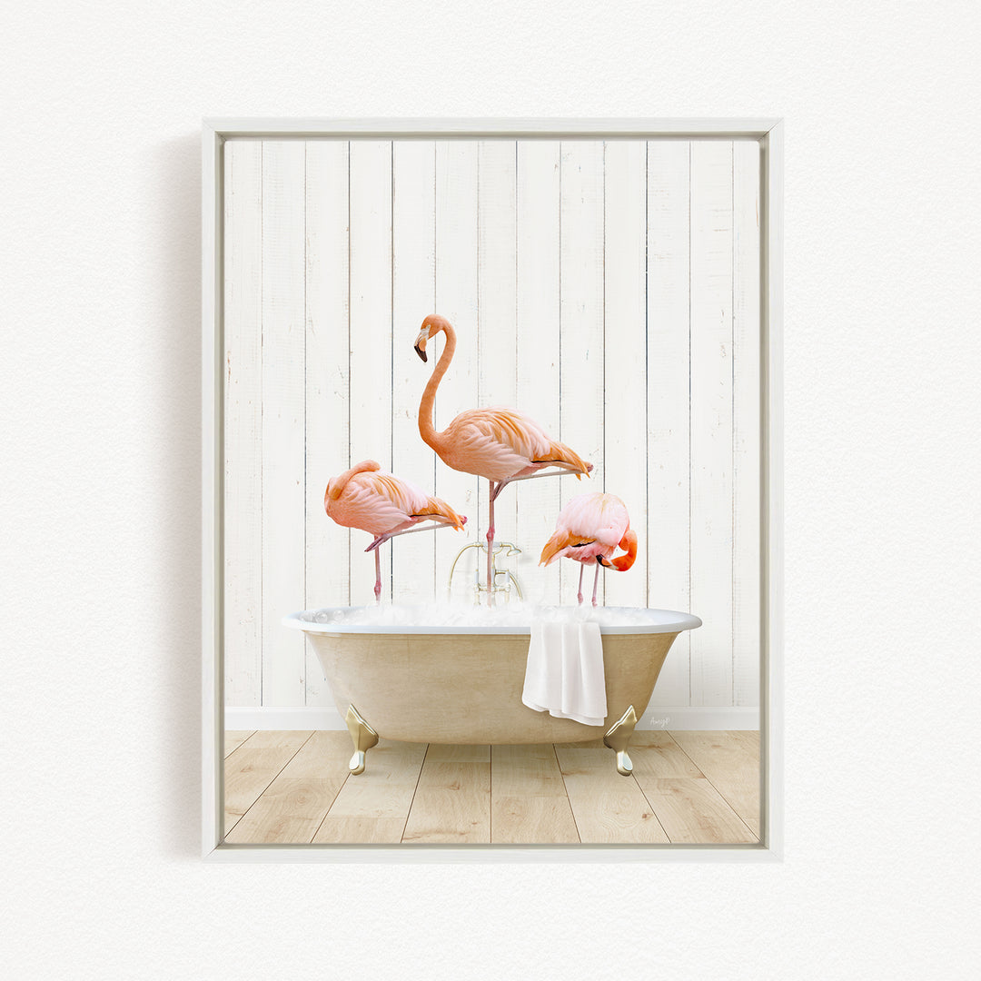 A framed image depicting three pink flamingos standing in a white bathtub filled with water, creating a whimsical and playful scene.
