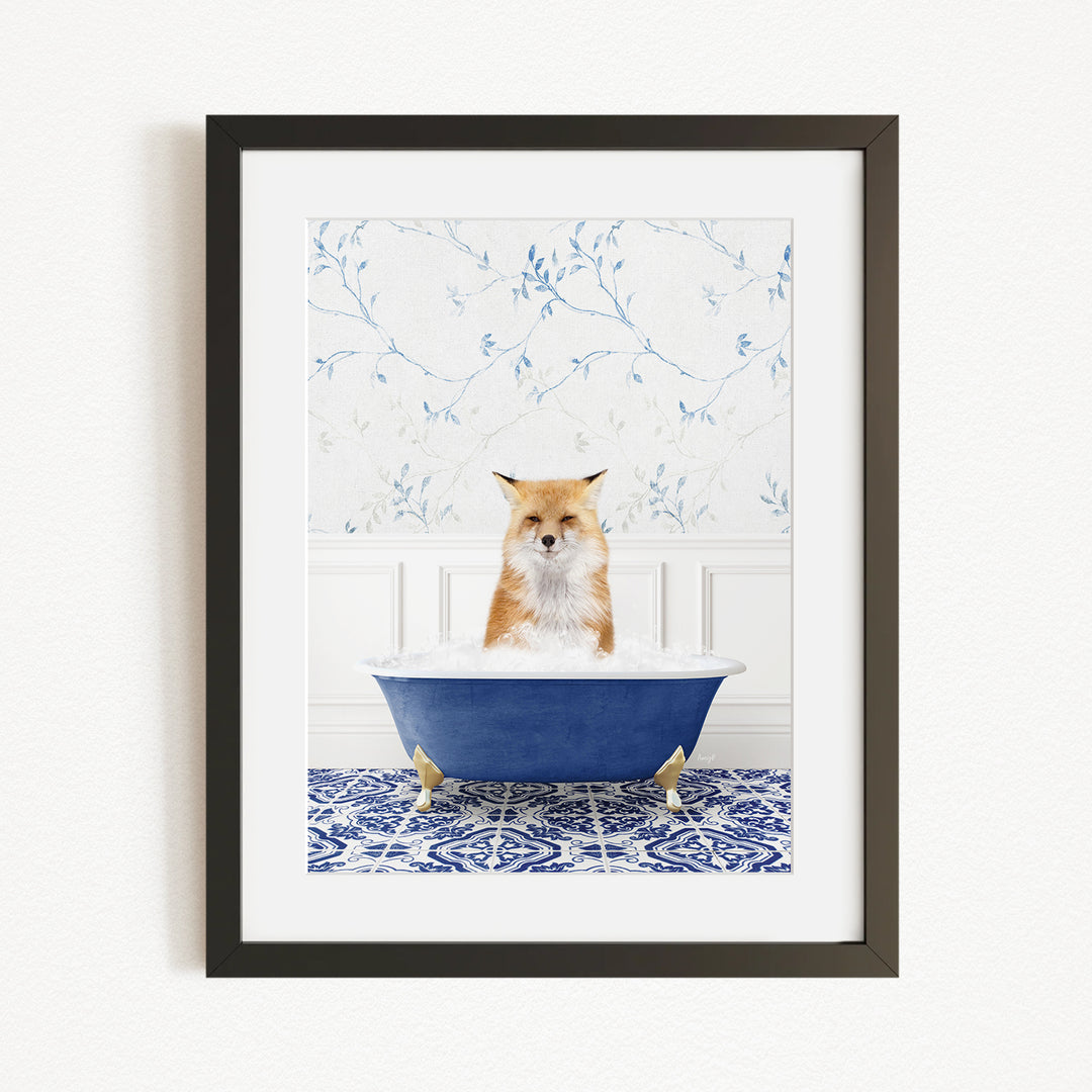 A red fox is sitting in a blue bathtub filled with bubbles, looking directly at the camera.