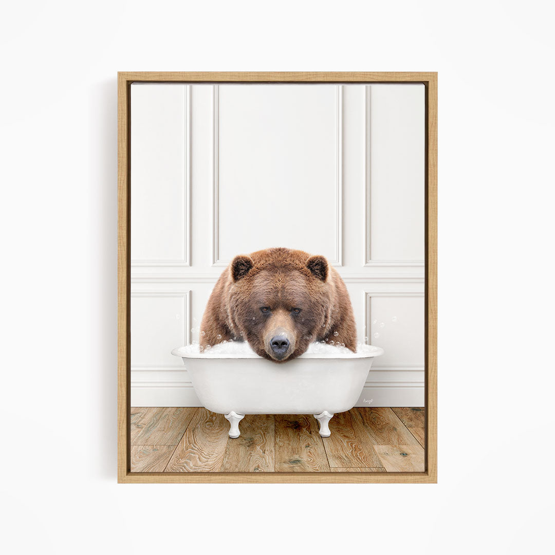 A brown bear is sitting in a white bathtub, appearing to be enjoying a relaxing bath.