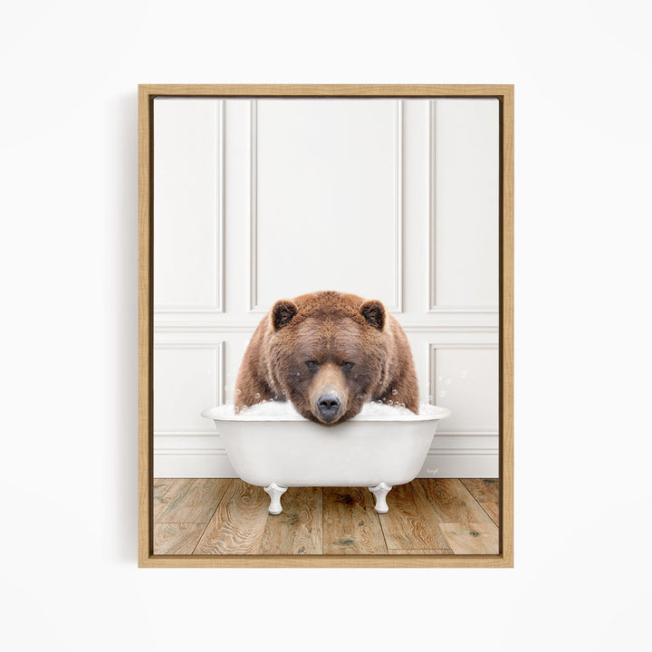 A brown bear is sitting in a white bathtub, appearing to be enjoying a relaxing bath.