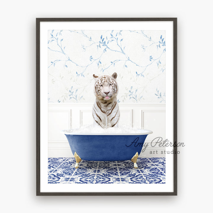 a white tiger sitting in a blue bath tub