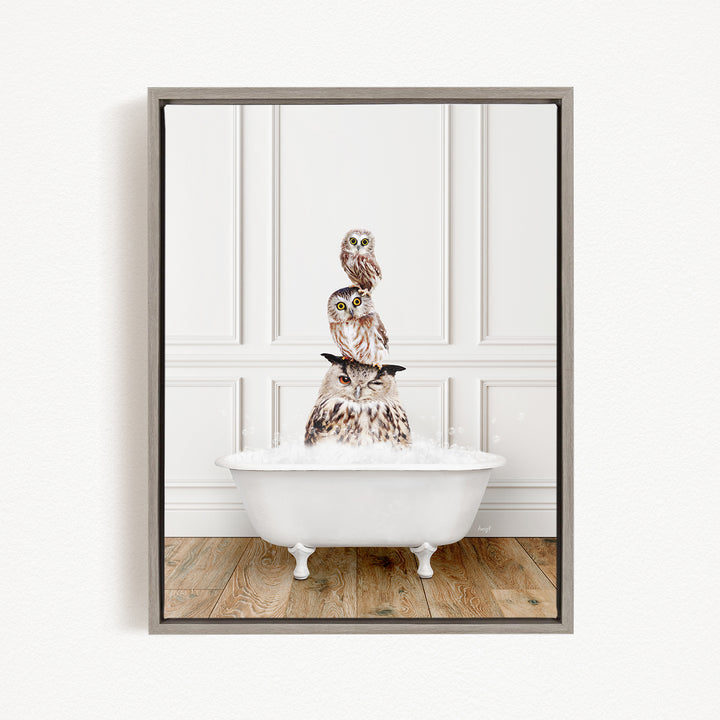 A framed image depicting three owls sitting in a white bathtub, with the owls' heads resting on the rim of the tub.