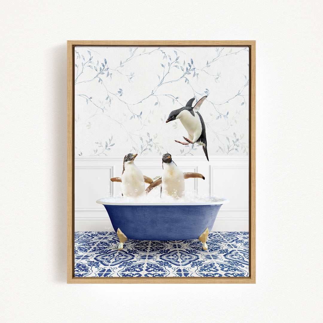 A framed image depicting two penguins sitting in a blue bathtub, with one penguin flying out of the tub.
