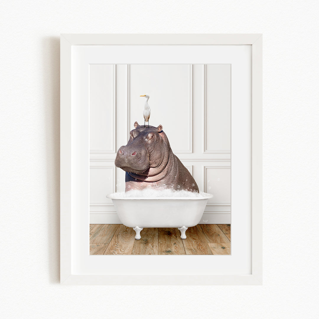 A framed image depicting a large hippopotamus sitting in a bathtub, with a seagull perched on its head.