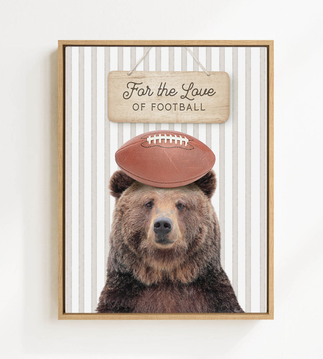 A framed image of a brown bear wearing a football helmet and standing in front of a sign that says "For the Love of Football".