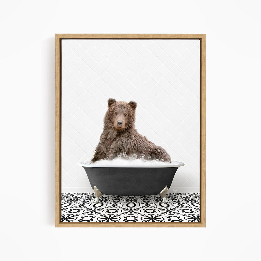 A brown bear sitting in a black bathtub filled with water, surrounded by a black and white patterned floor.