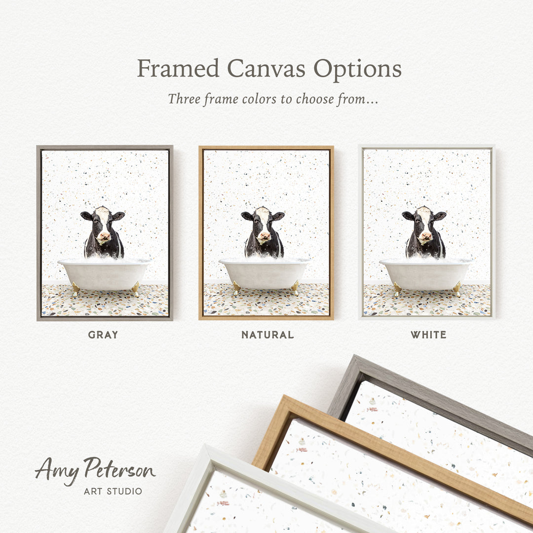 three framed canvas options featuring a cow in a bathtub, with each option having a different frame color: gray, natural, and white.