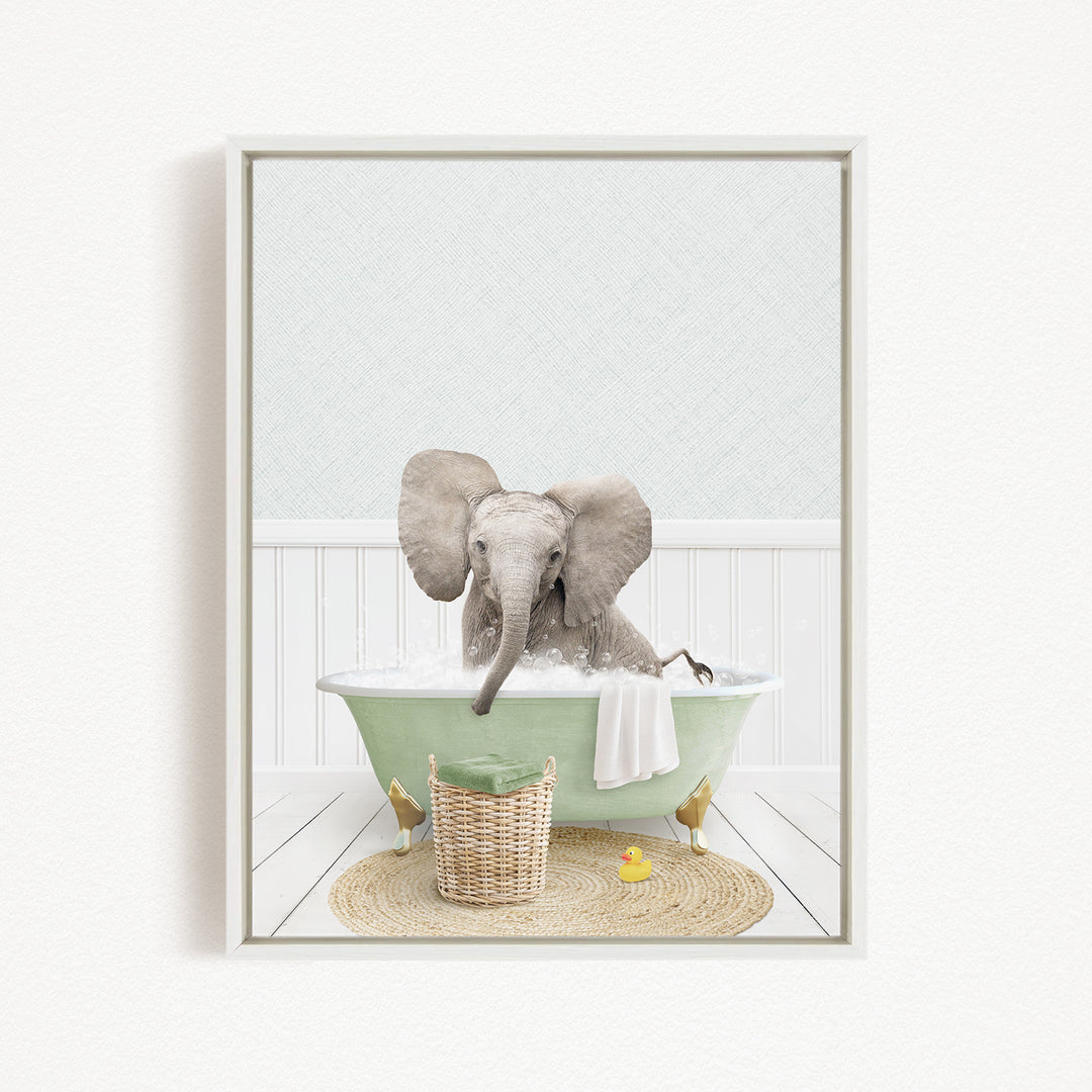 A gray elephant is sitting in a green bathtub filled with water, surrounded by a basket of toys and a yellow rubber duck.