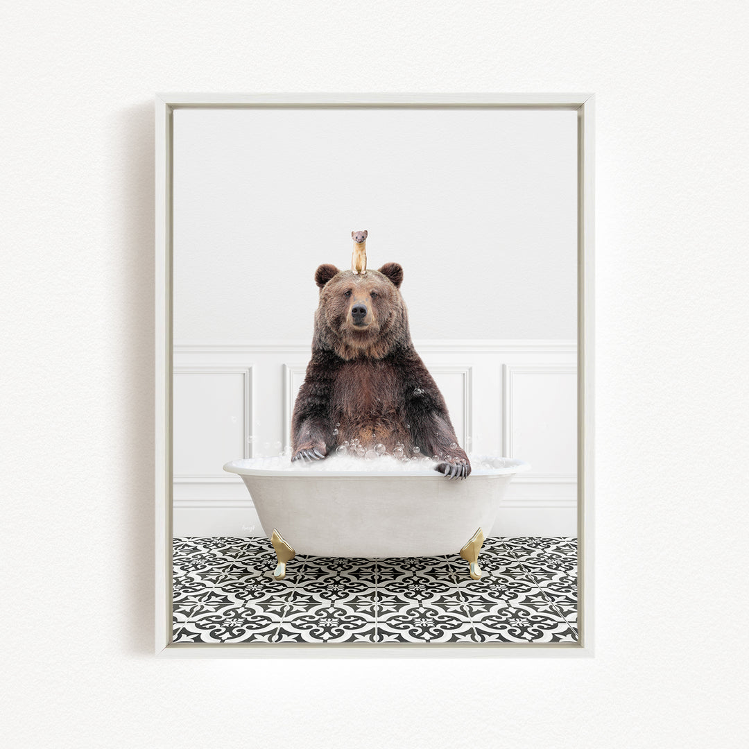 A brown bear sitting in a white bathtub, with a small animal perched on its head.