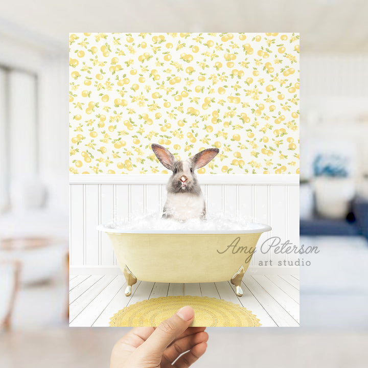 a person holding up a picture of a rabbit in a bathtub