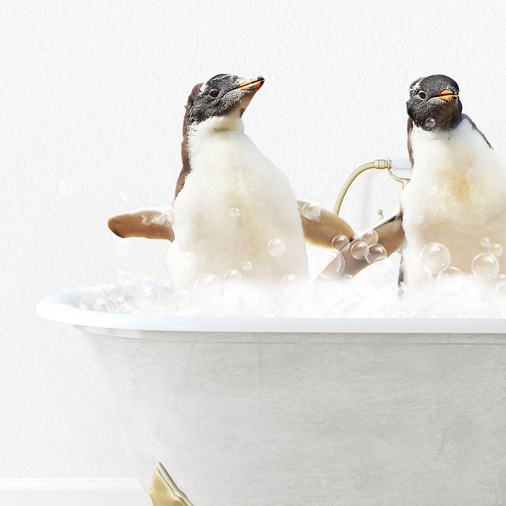 two penguins sitting in a bathtub with bubbles