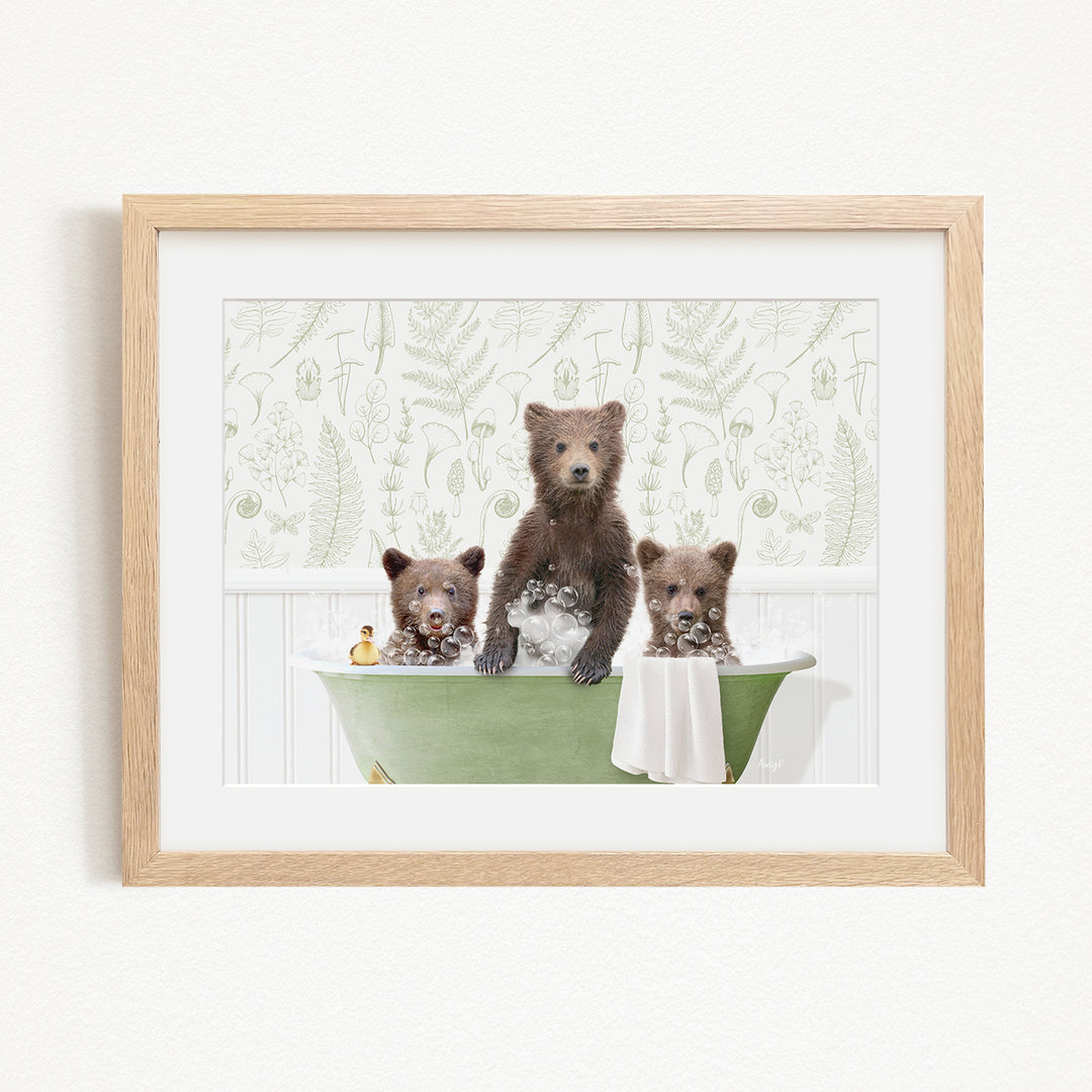 A framed image depicting three bears sitting in a green bathtub filled with bubbles, surrounded by a patterned wall.