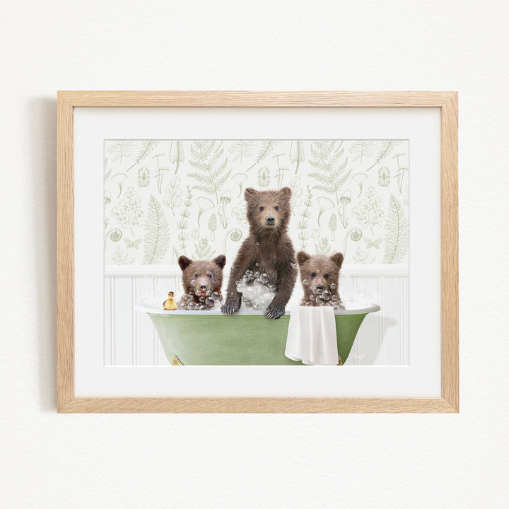 A framed image depicting three bears sitting in a green bathtub filled with bubbles, surrounded by a patterned wall.