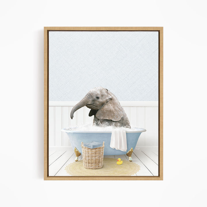A gray elephant is sitting in a blue bathtub filled with water, surrounded by a basket of rubber ducks and a towel.