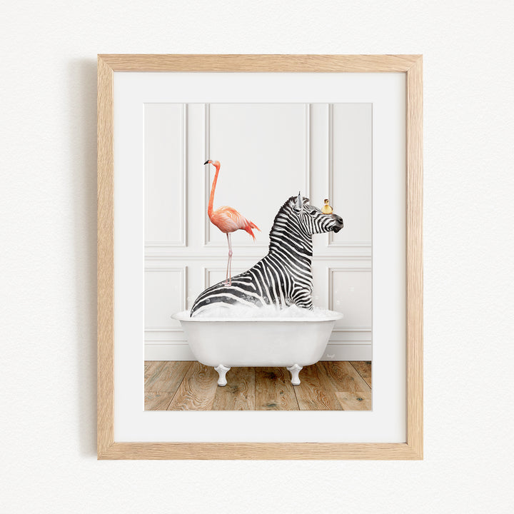 A framed image depicting a zebra sitting in a bathtub, with a flamingo standing on its back.