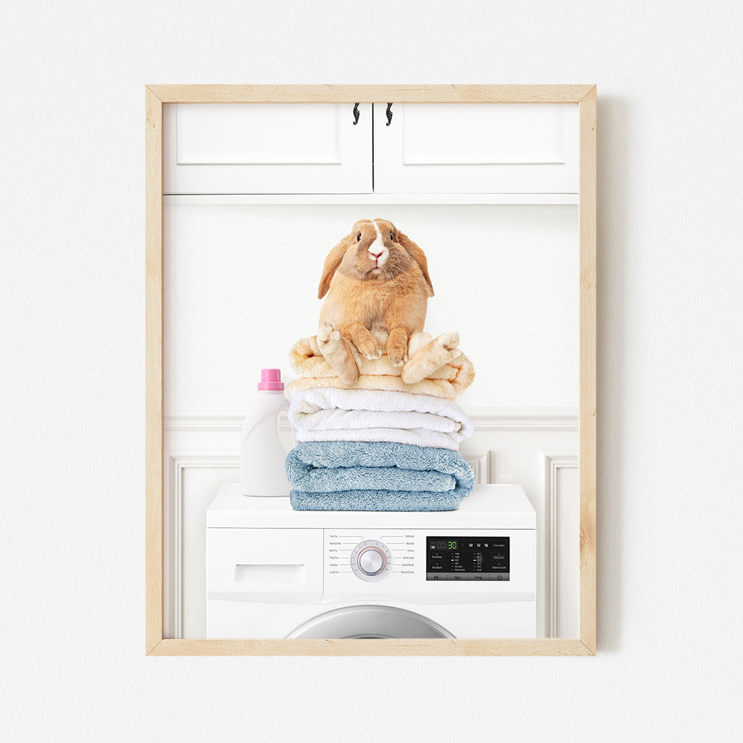 a rabbit sitting on top of a stack of towels