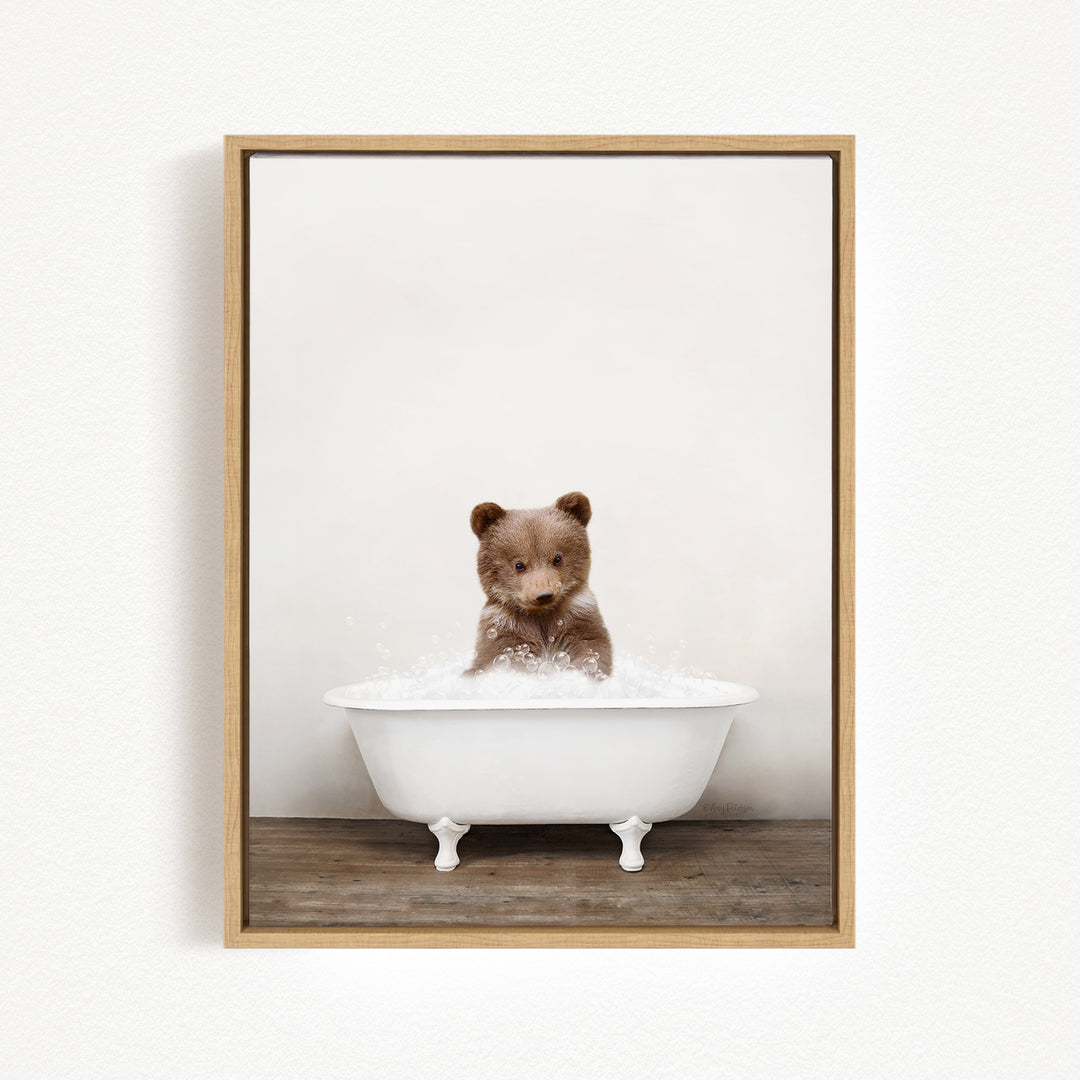 A brown bear sitting in a white bathtub filled with water, creating a playful and whimsical scene.