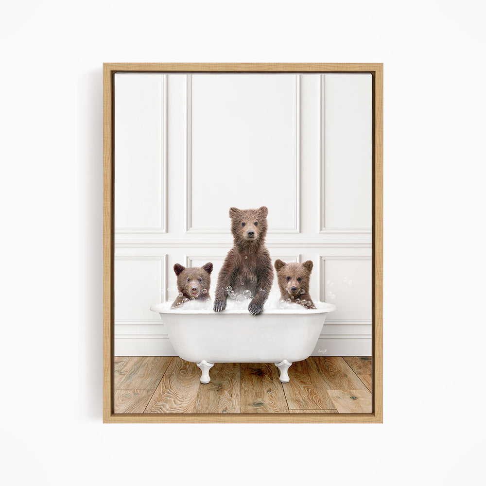 A framed image depicting three brown bears sitting in a white bathtub, with one bear sitting at the center and the other two bears sitting on either side.