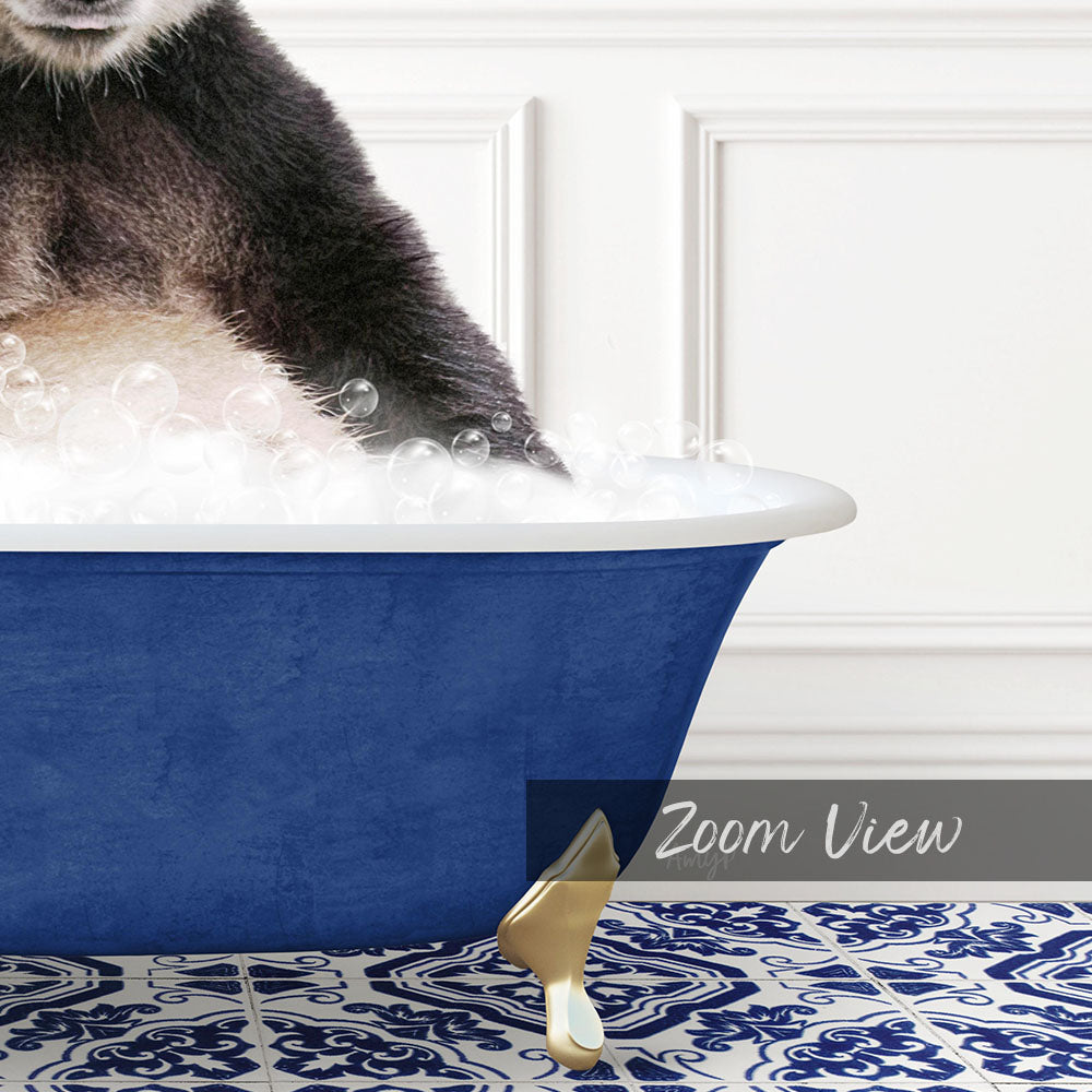A cat is sitting in a blue bathtub filled with bubbles, with its paw in the water.