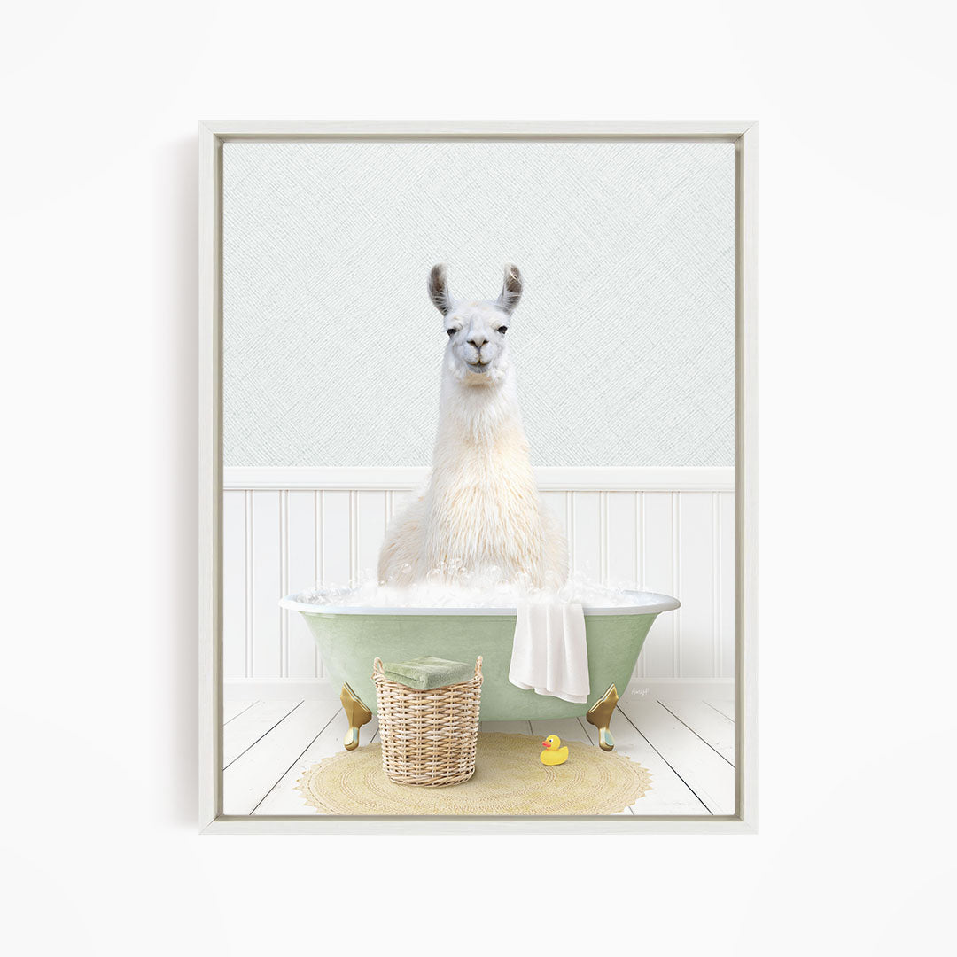 A white llama sitting in a green bathtub filled with bubbles, surrounded by a yellow rubber duck and a wicker basket.