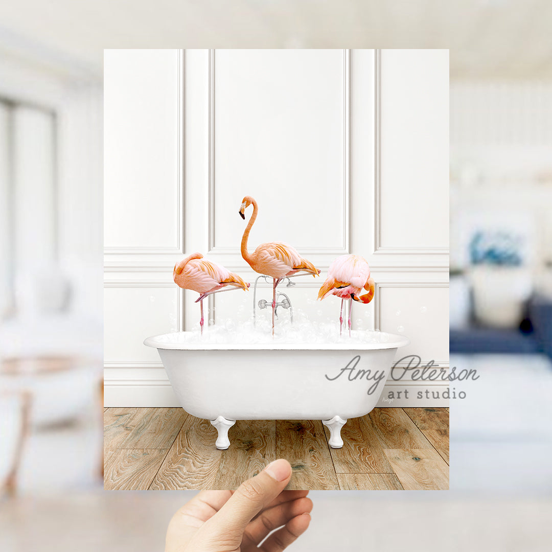 a person holding up a photo of flamingos in a bathtub