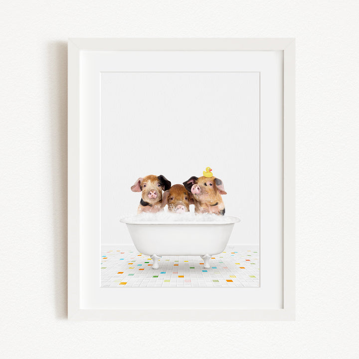 Three adorable pigs sitting in a white bathtub filled with bubbles, with one of them wearing a yellow hat.