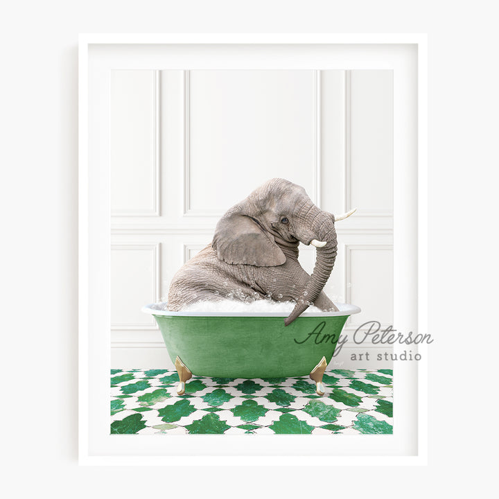 a baby elephant sitting in a green bath tub