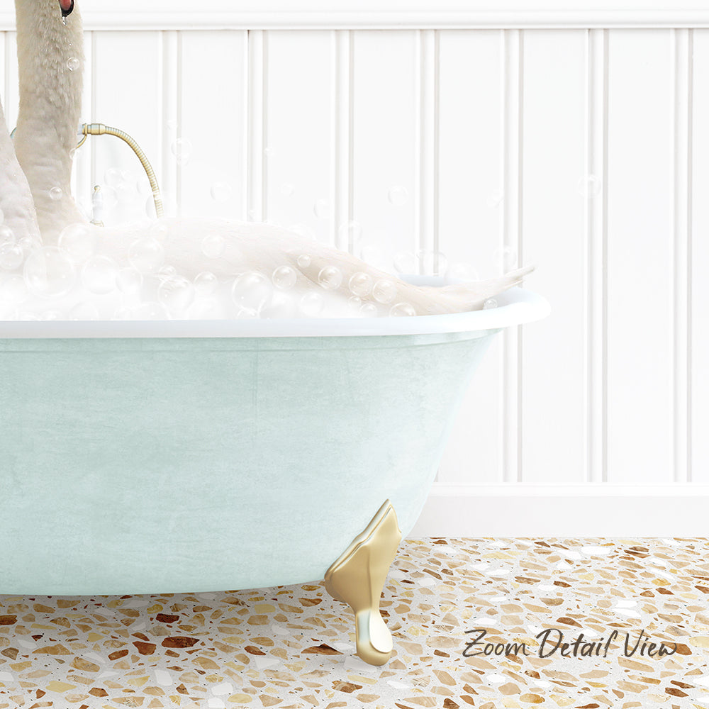 A white bathtub filled with bubbles, with a gold-colored claw-foot design, and a person sitting in the tub.