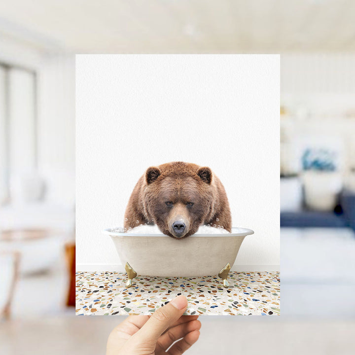 A brown bear is sitting in a bathtub filled with water, appearing to enjoy the bath.