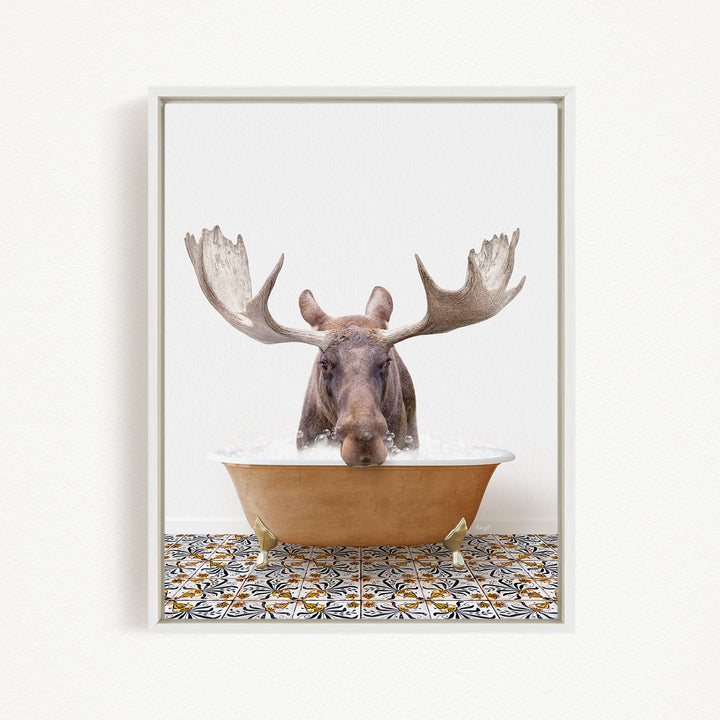 A moose with large antlers is sitting in a bathtub filled with water, creating a whimsical and humorous scene.