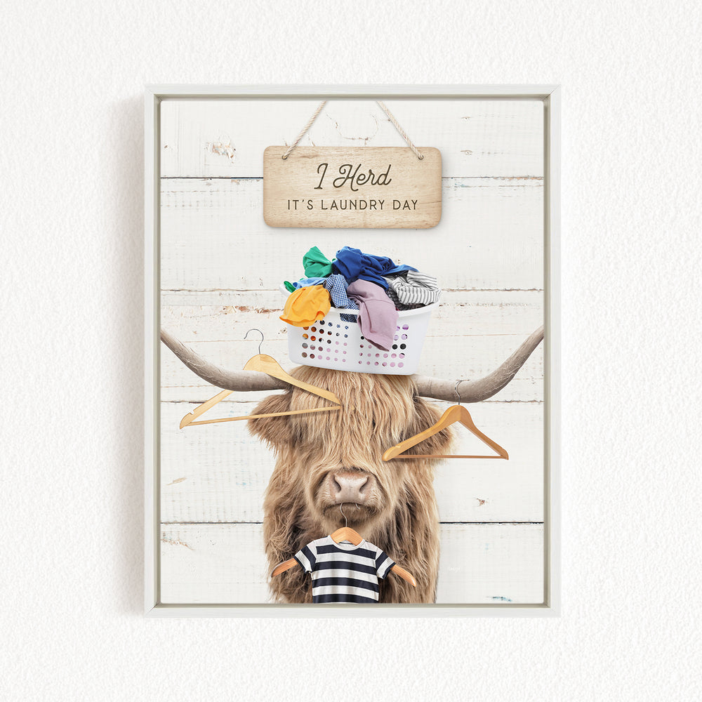 A humorous collage featuring a cow with a basket of laundry on its head, accompanied by a sign that reads "I herd it's laundry day".