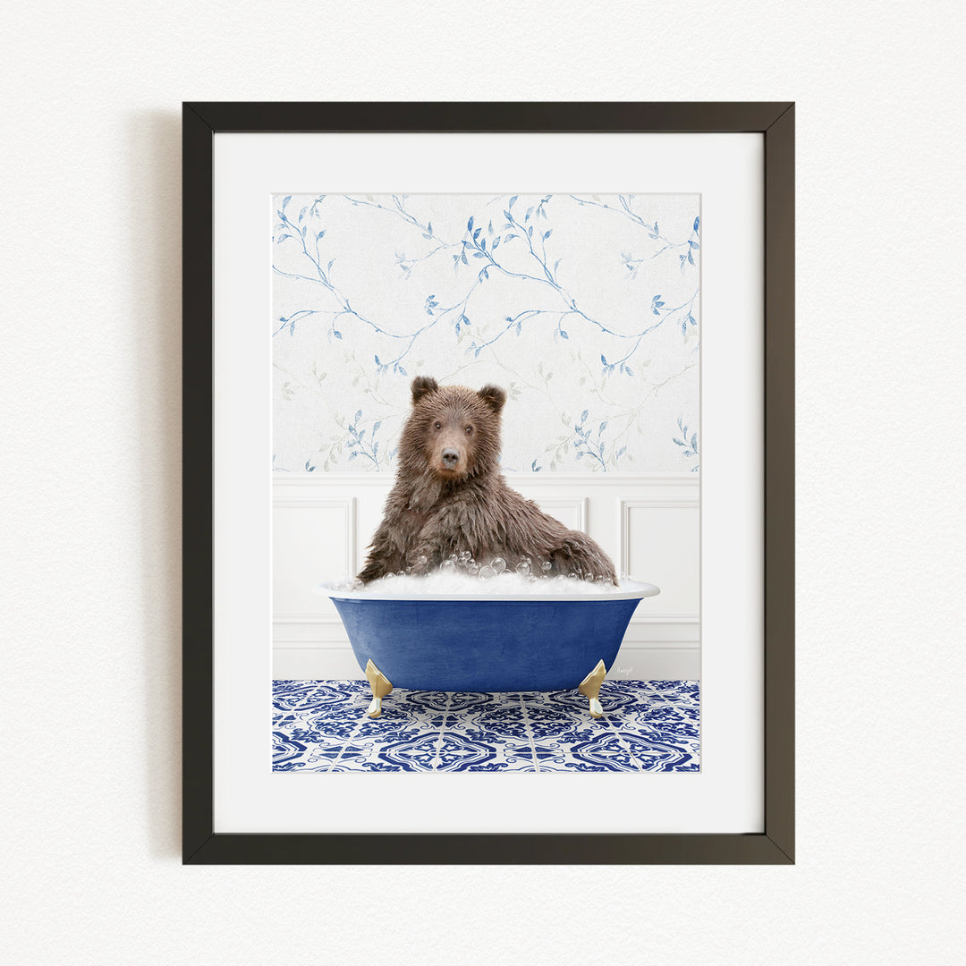 A brown bear sitting in a blue bathtub filled with bubbles, with a patterned tile floor and a floral wallpaper in the background.