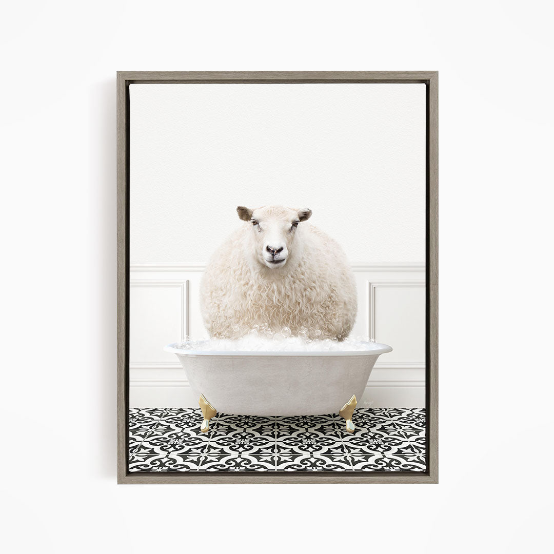 A fluffy white sheep sits in a white bathtub filled with bubbles, surrounded by a black and white patterned floor.