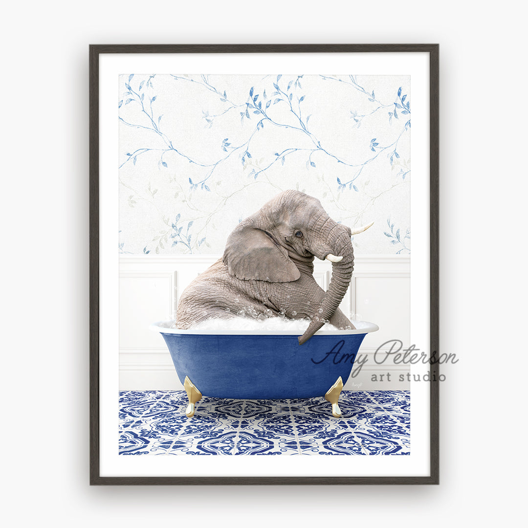 a baby elephant sitting in a blue bath tub