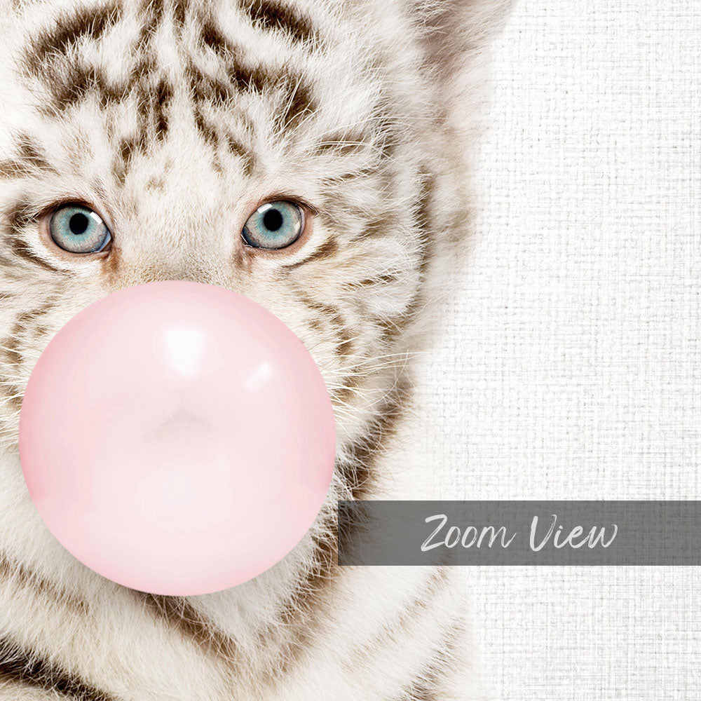 A close-up of a cat's face with its eyes open, looking directly at the camera, and blowing a pink bubble with a bubble gum bubble wand.