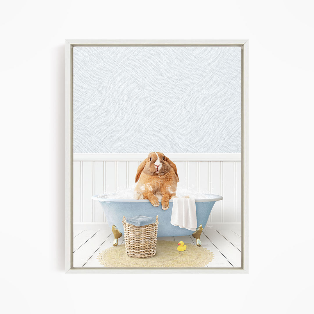 A brown rabbit sitting in a blue bathtub filled with water, surrounded by a yellow rubber duck and a basket.