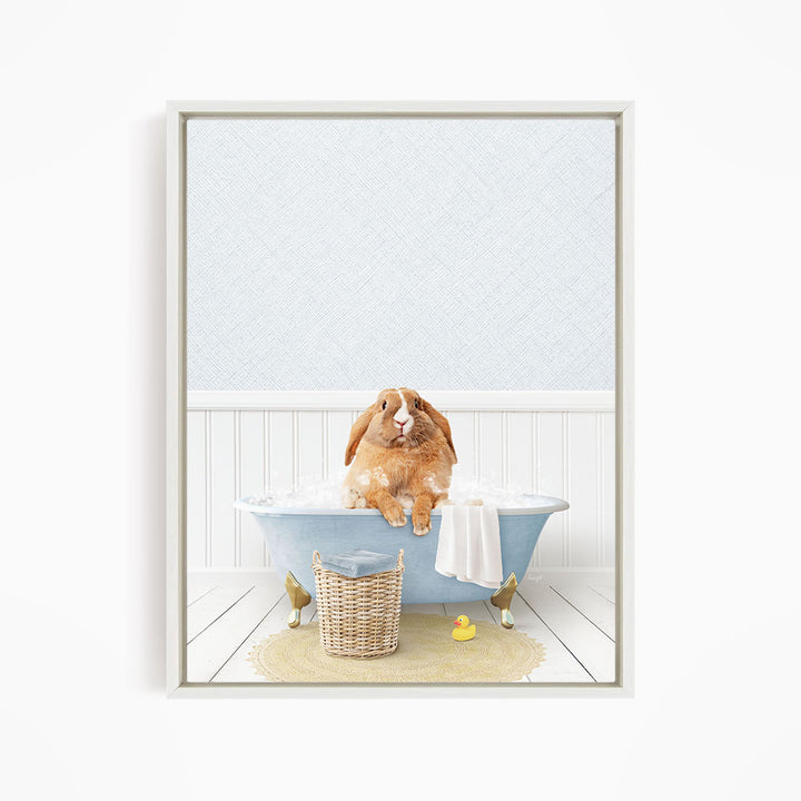 A brown rabbit sitting in a blue bathtub filled with water, surrounded by a yellow rubber duck and a basket.