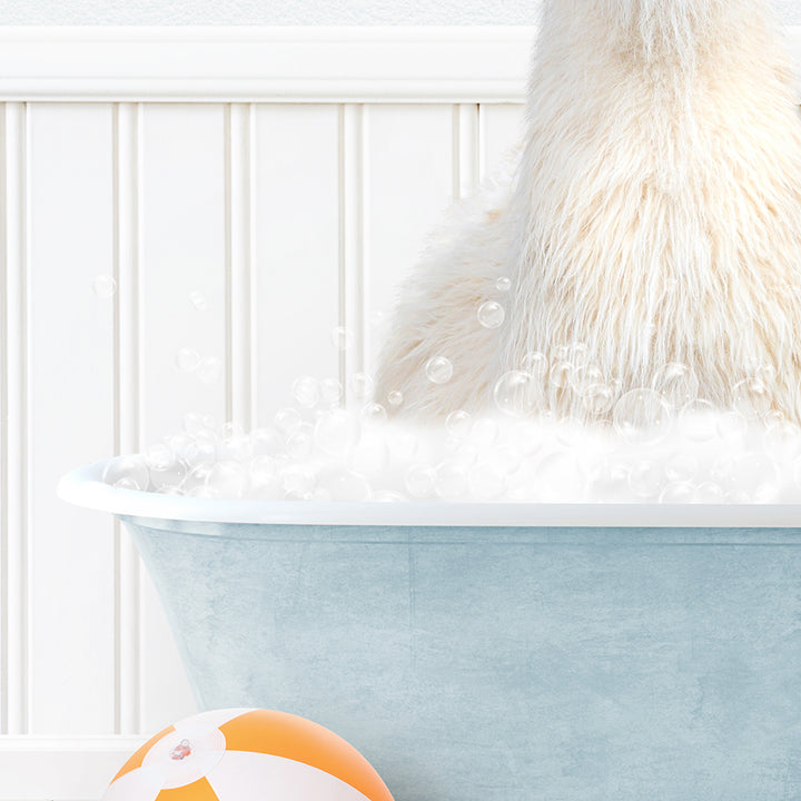 a polar bear sitting in a bathtub with bubbles