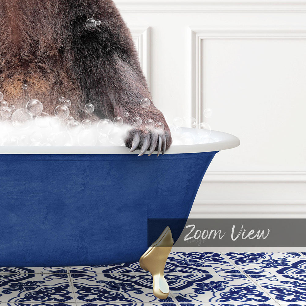 A close-up of a bear's paw resting on the edge of a blue bathtub filled with bubbles, with a white wall and patterned floor in the background.