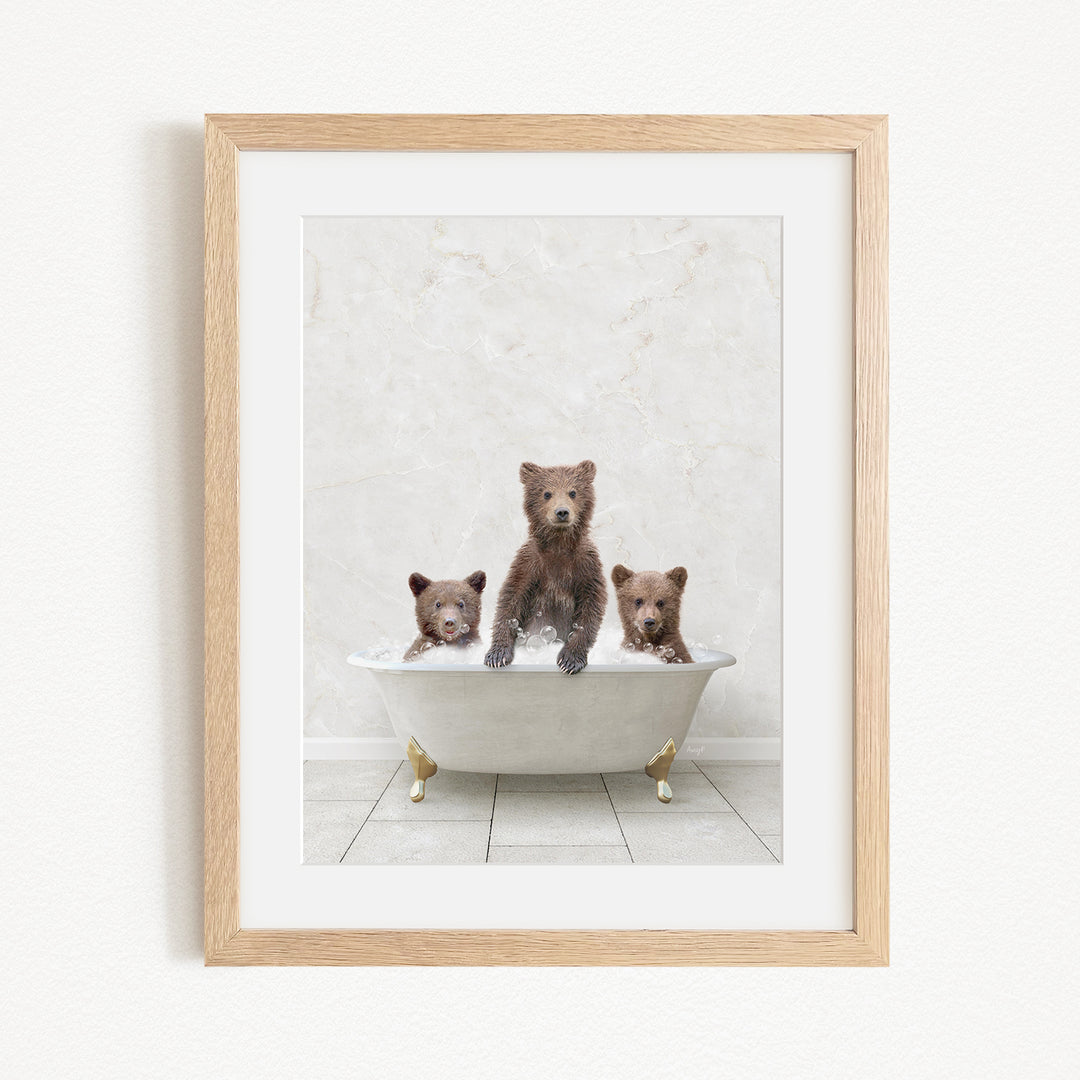 A framed image depicting three bears sitting in a bathtub, with one bear sitting in the center and the other two bears sitting on either side.