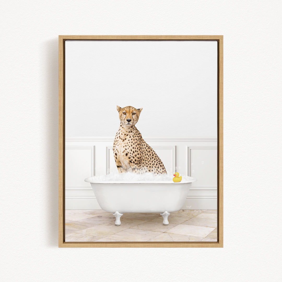 A cheetah sitting in a white bathtub filled with water, with a rubber duck floating in the water.
