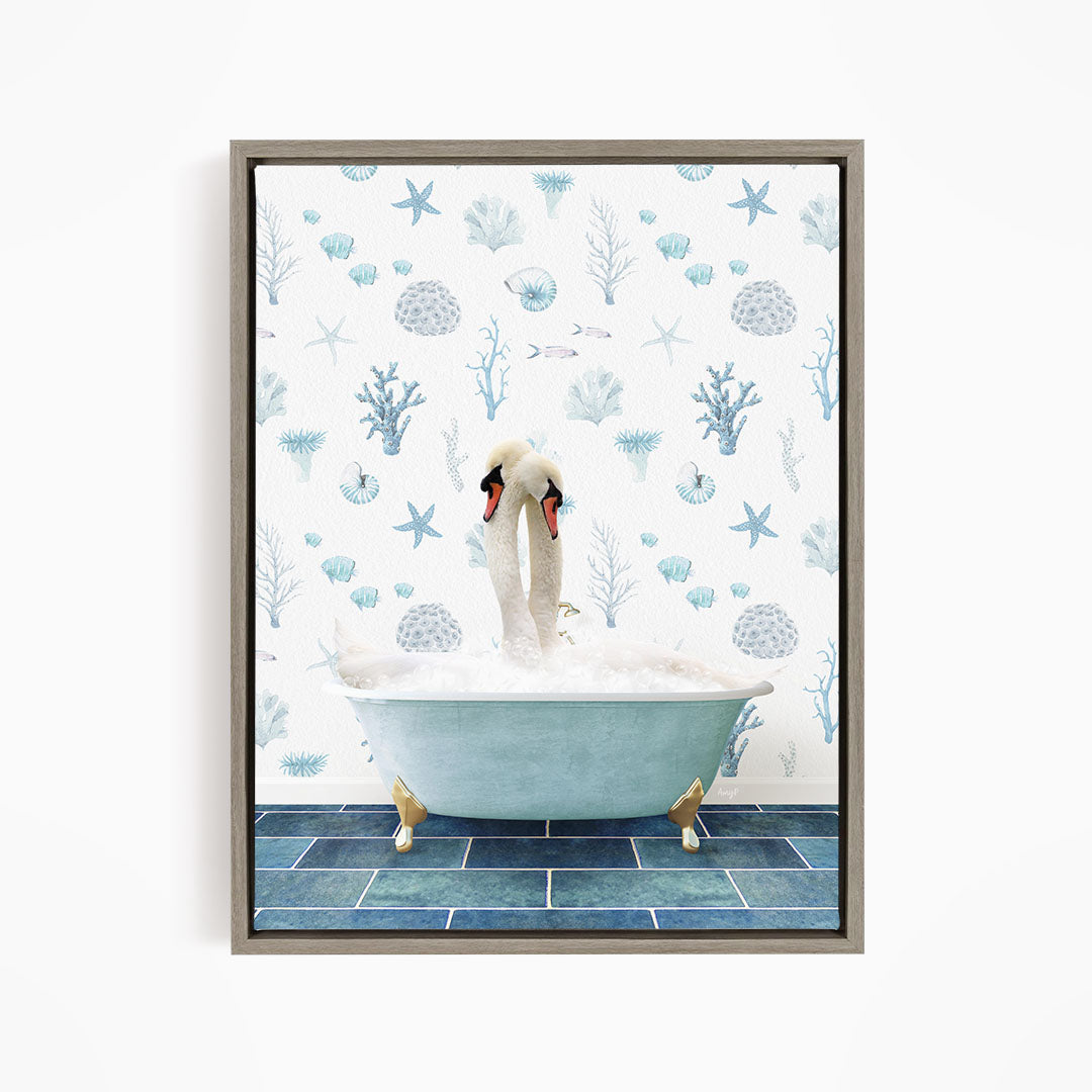 A framed image depicting a pair of swans sitting in a bathtub filled with bubbles, surrounded by a blue and white ocean-themed wallpaper.